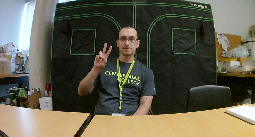 Picture of Centennial student Roman Kolomoyets who grows strawberries in his LED-equipped indoor tent